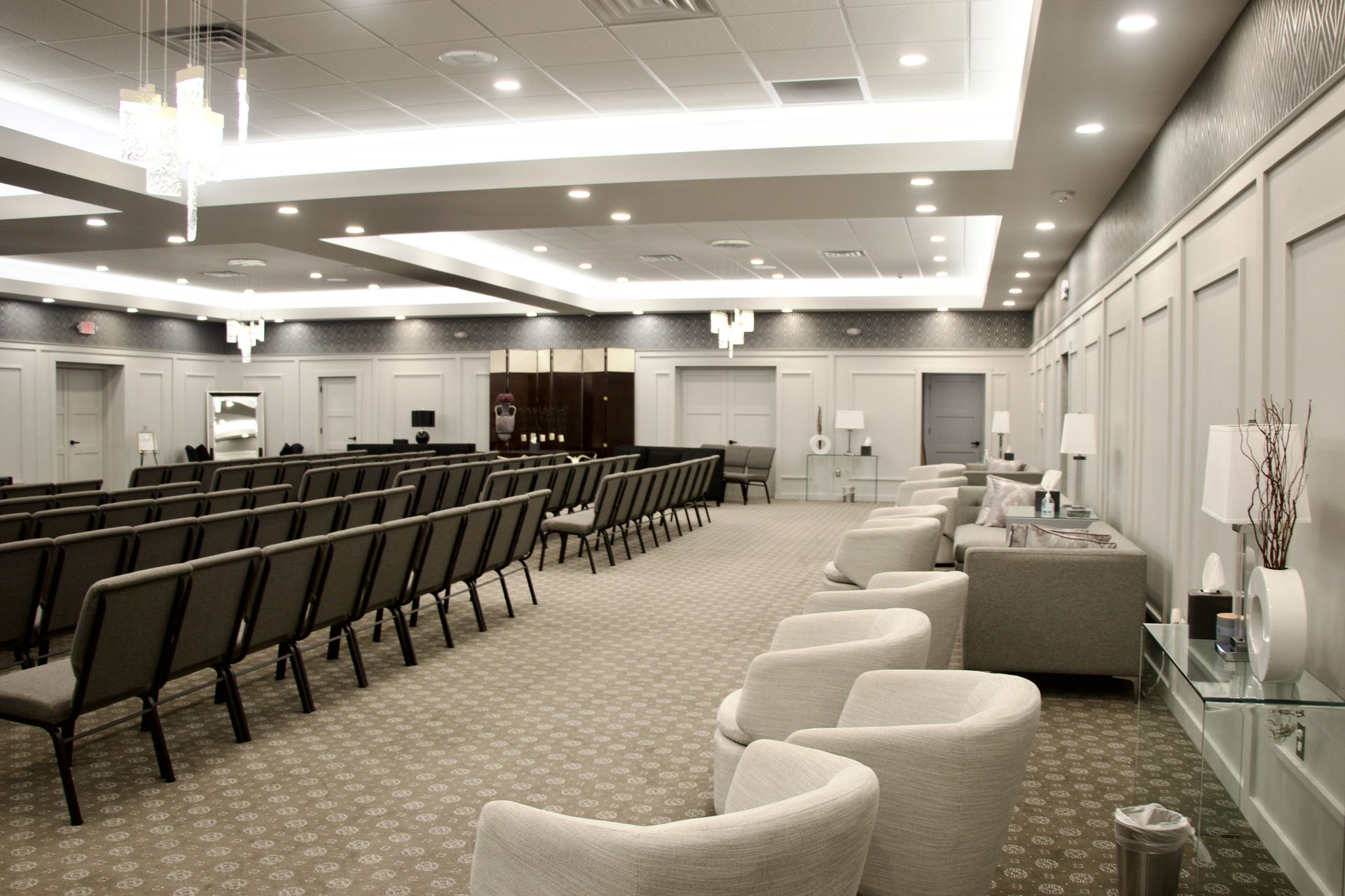 A large room with rows of chairs and a couch in it.