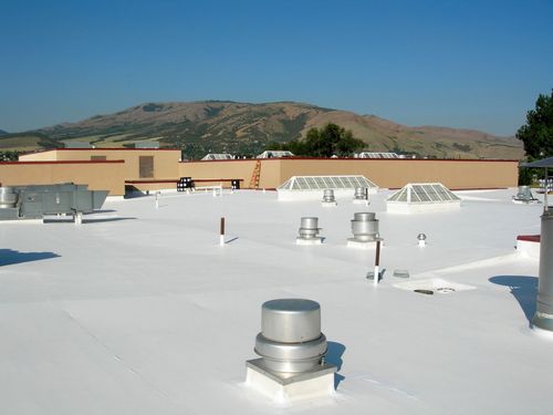 A white roof with a lot of vents on it