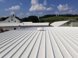 A white roof of a building with a blue sky in the background.