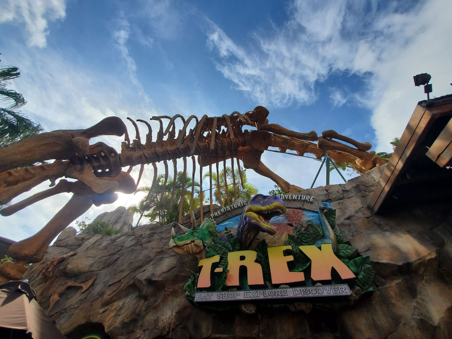 A large dinosaur skeleton is above a sign that says trex