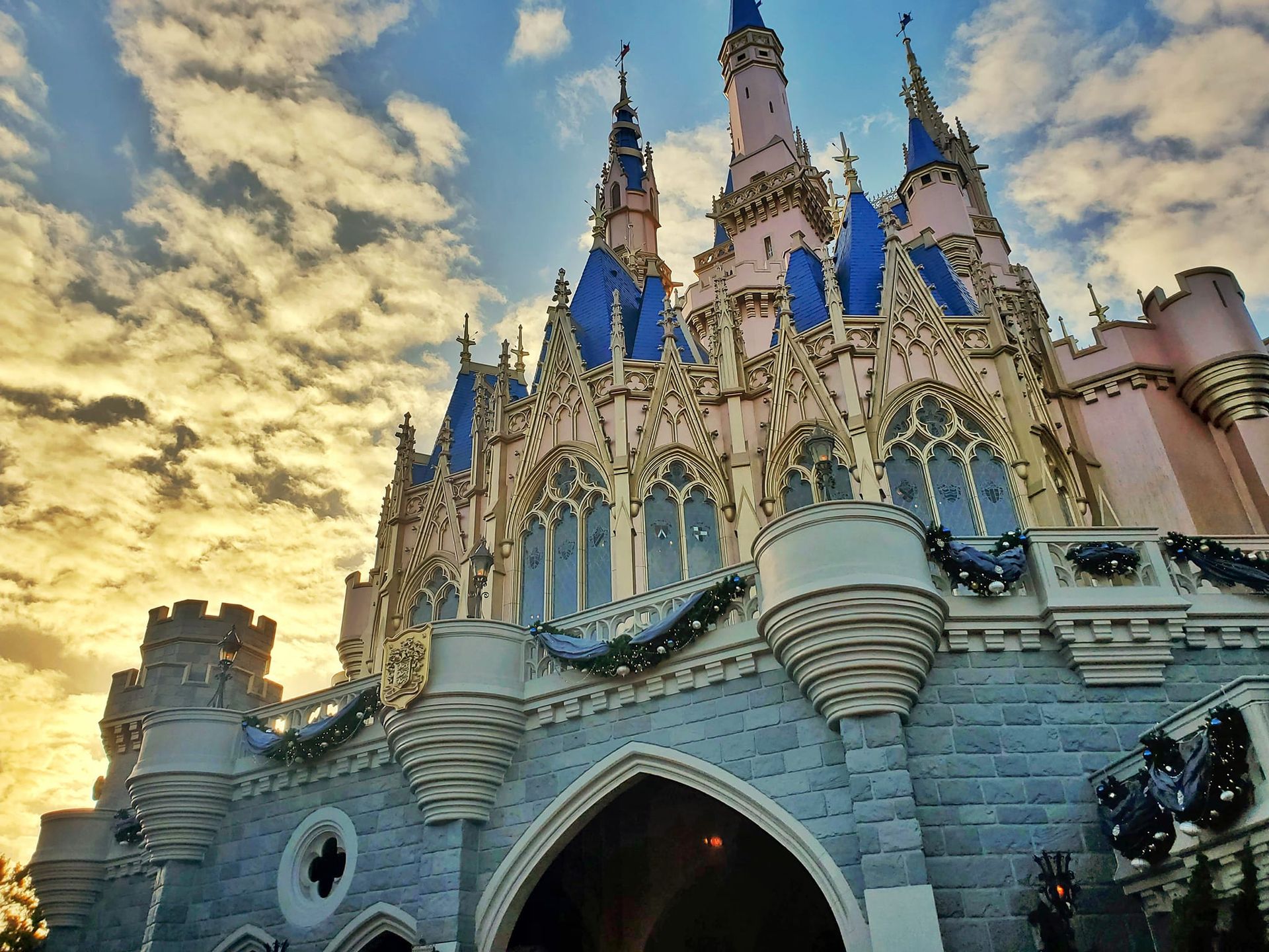 A large castle with a sunset in the background