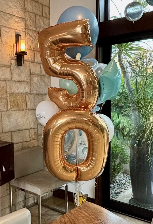 50th birthday balloon delivery Los Angeles — gold number balloons and organic garland — Balloon Concierge