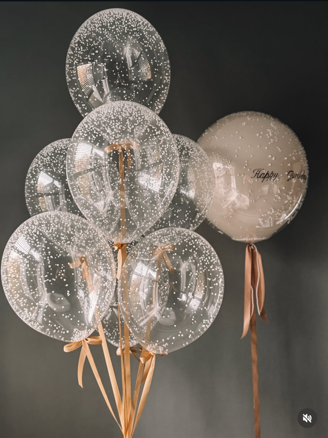 clear balloon with white confetti dots ribbon strings