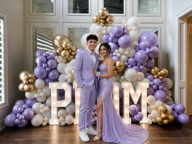 Prom send-off balloon backdrop decoration at Los Angeles home — couple in formal wear posing in front of luxury balloon wall — Balloon Concierge