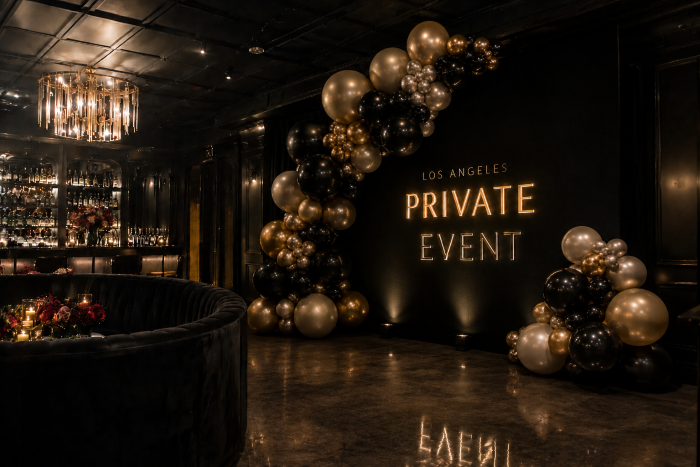Luxury balloon installation at an exclusive Los Angeles private event venue with dramatic ambient lighting