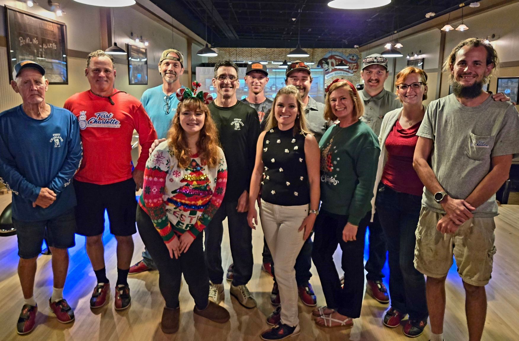 A group of people are posing for a picture in a garage.