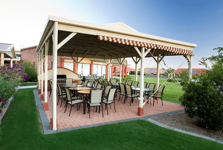 Outdoor Dining Area Under a Wooden Gazebo — Ground Control Property Maintenance In North Boambee Valley, NSW