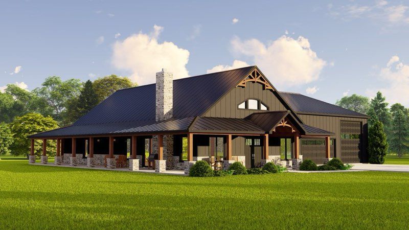 Large modern farmhouse with dark roof, stone accents, and a wide porch on a green lawn under a blue sky
