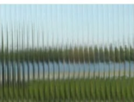 A picture of a lake through a glass window.