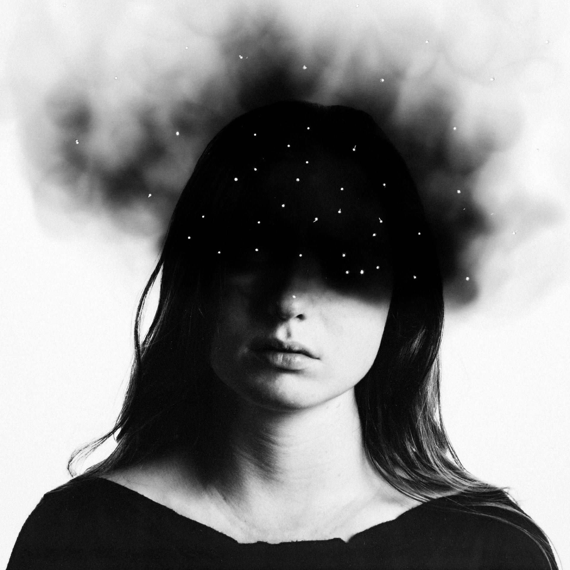A black and white photo of a woman with smoke coming out of her head