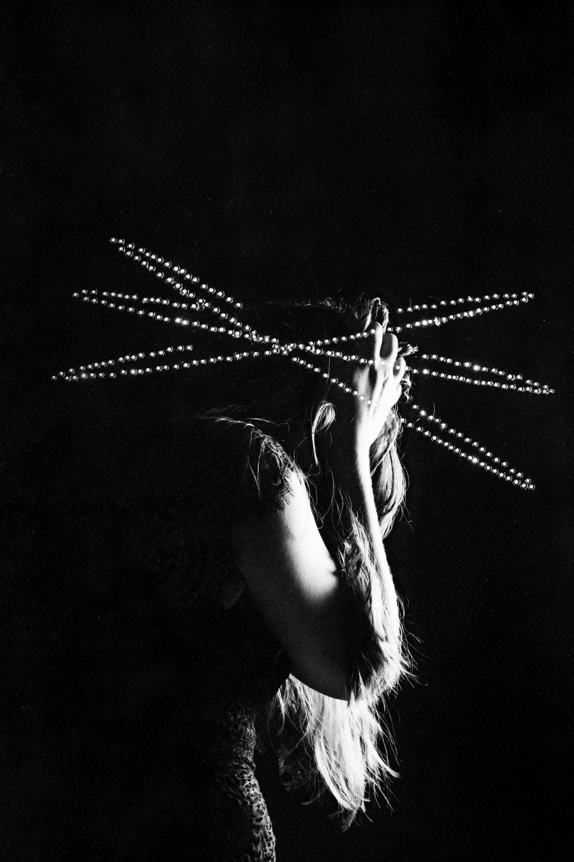 A black and white photo of a woman holding a string in her hand