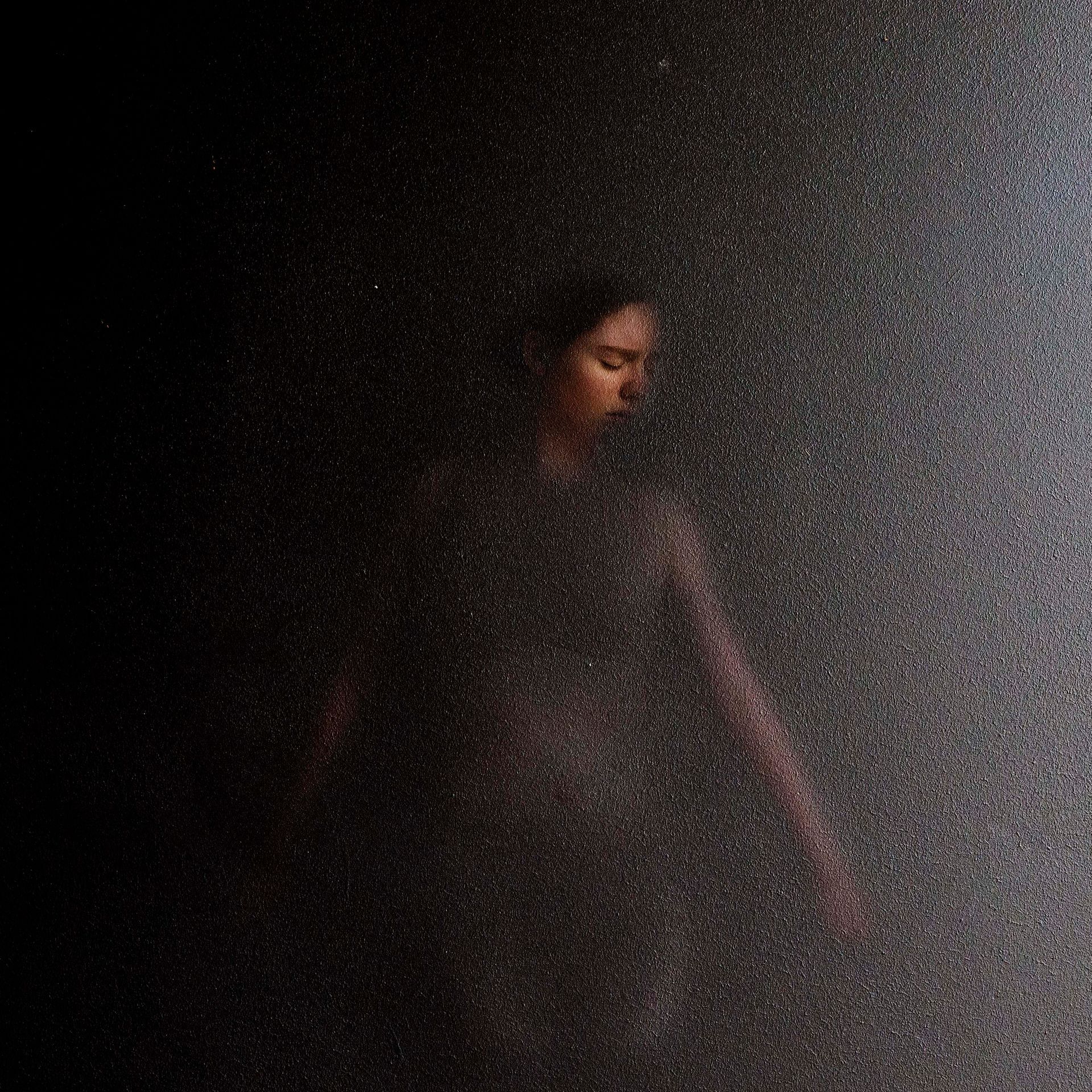 A blurry picture of a person standing in the dark