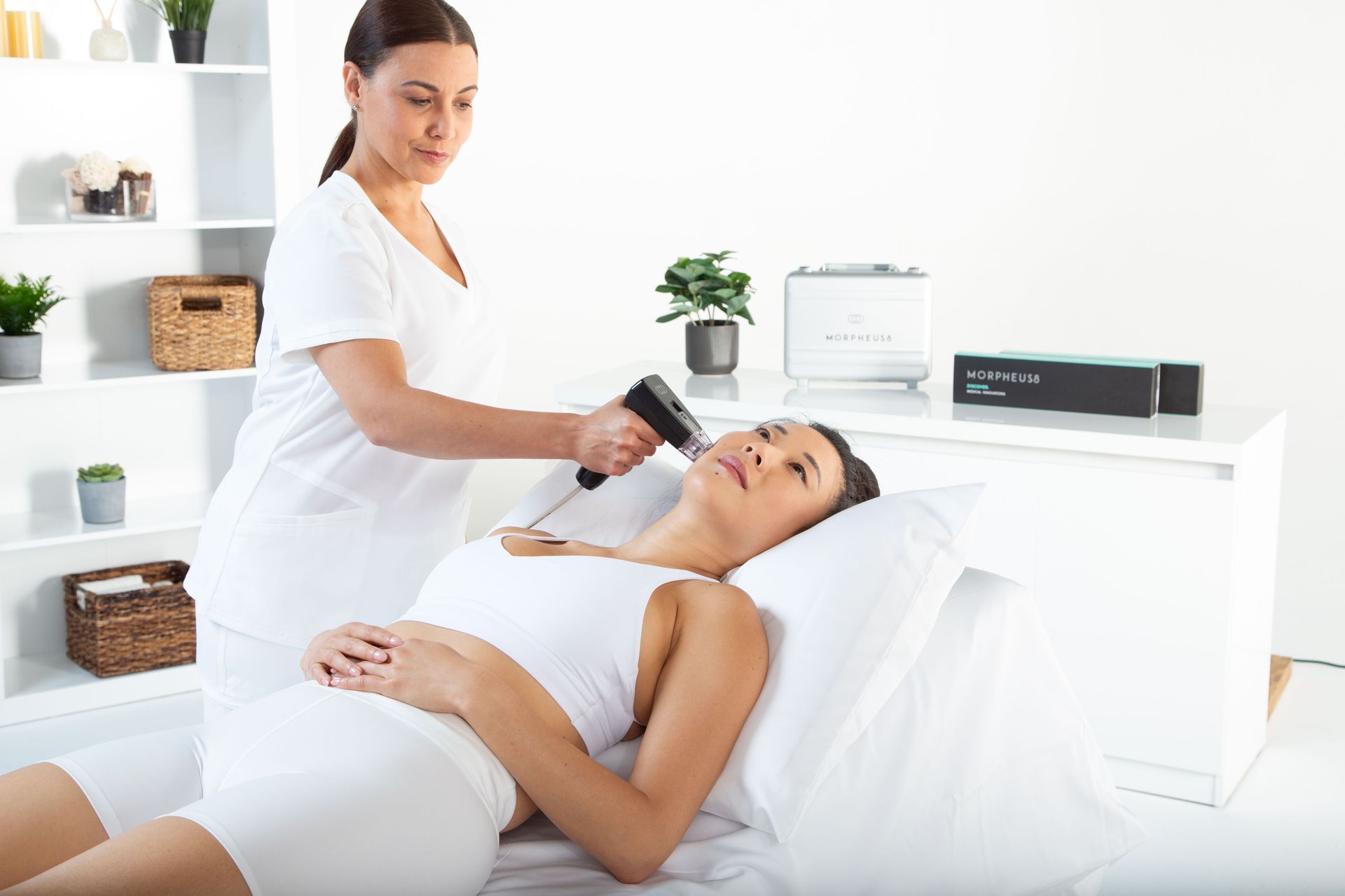 A person receiving a skin treatment on their neck, in a medical setting.