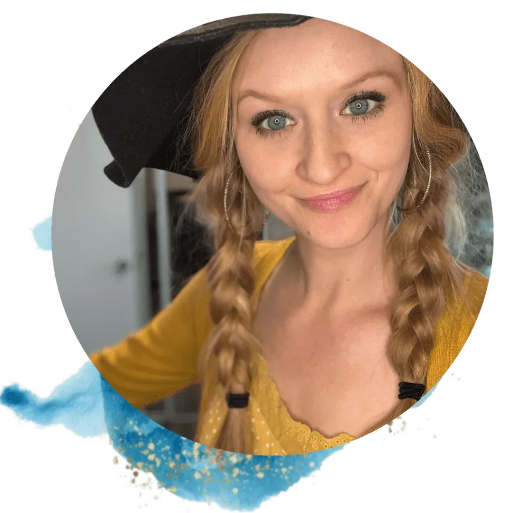 Woman with blonde braids and hat smiles, wearing yellow top.