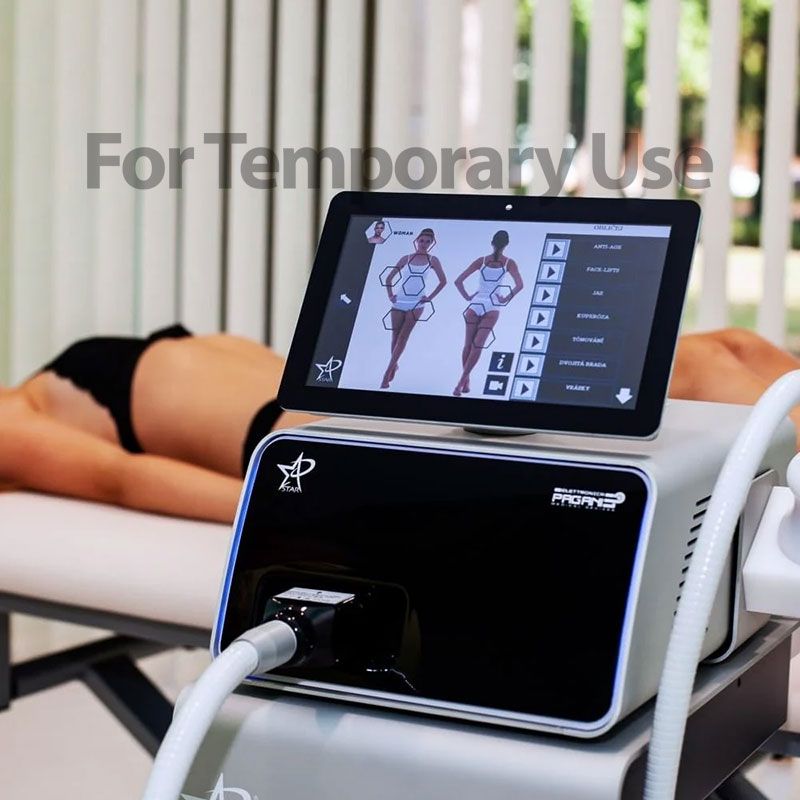 Woman receiving body treatment with a machine. The machine is on a table. The woman is lying down.