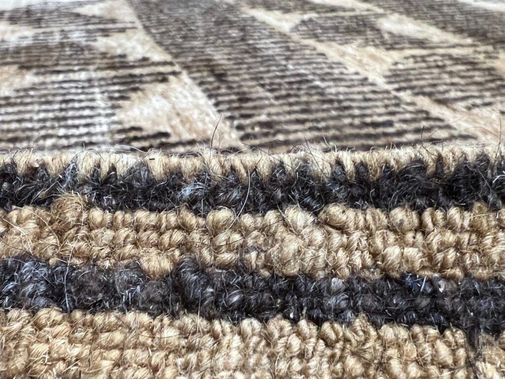 Selvedge rug fringes on a wool rug.