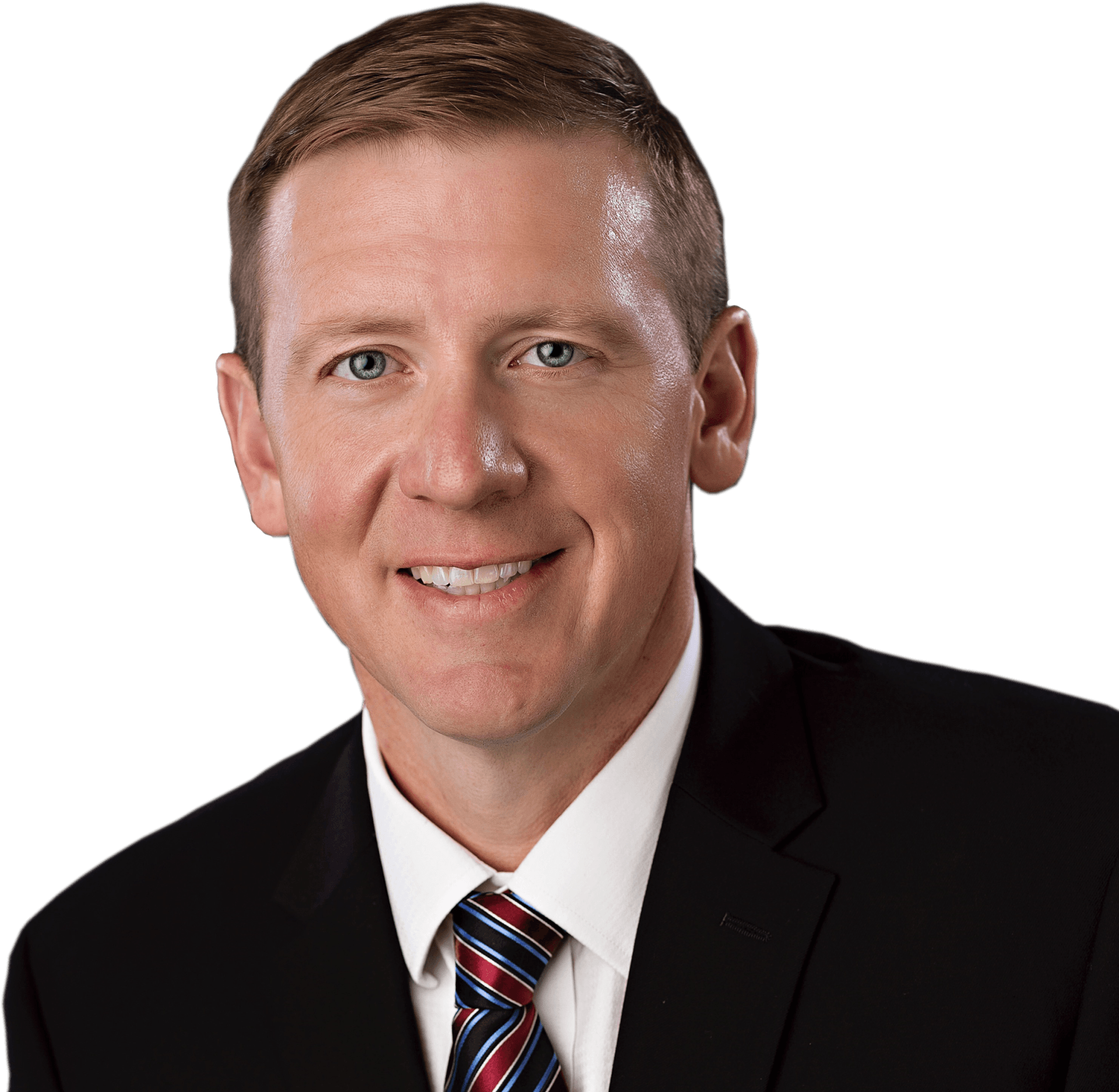 A man in a suit and tie is smiling for the camera