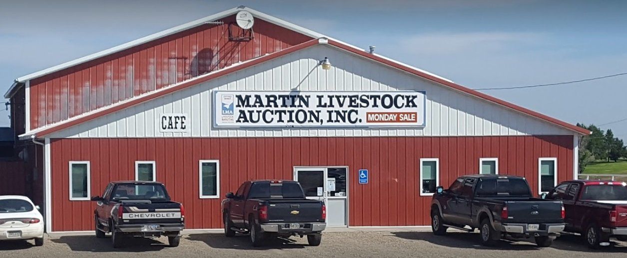 A red and white building with trucks parked in front of it.