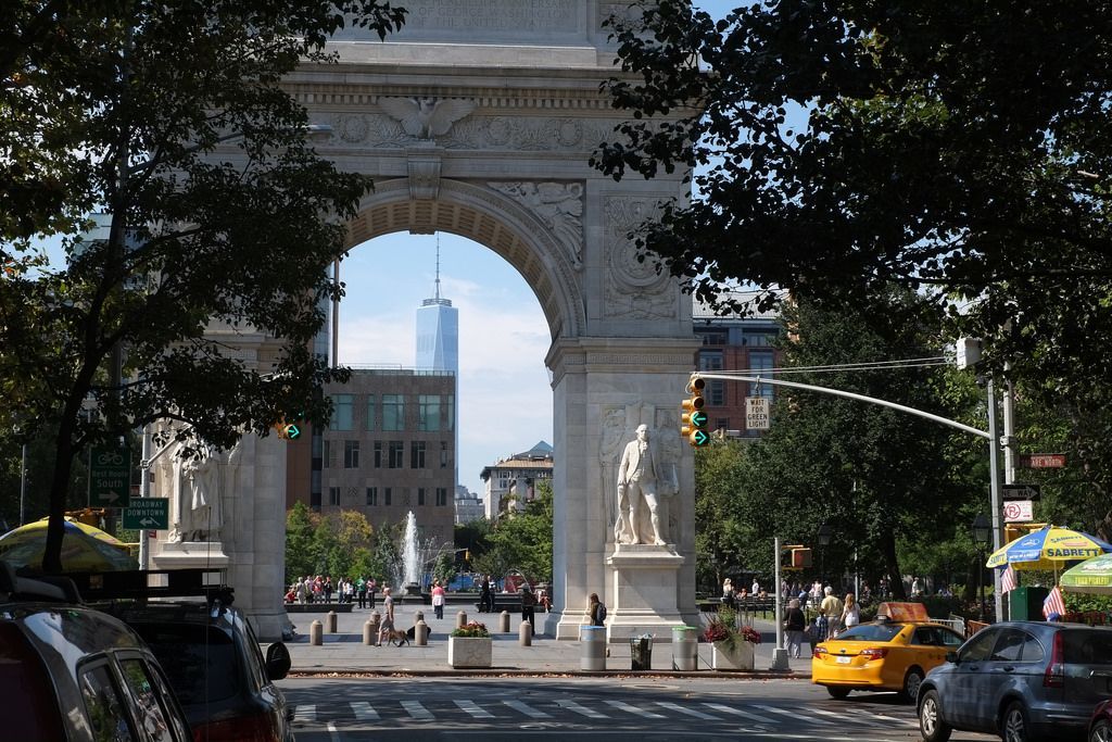 A city street with a statue in the middle of it