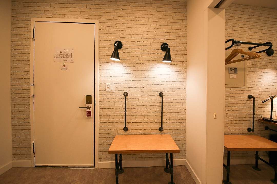 There is a table in the middle of the room next to a door.