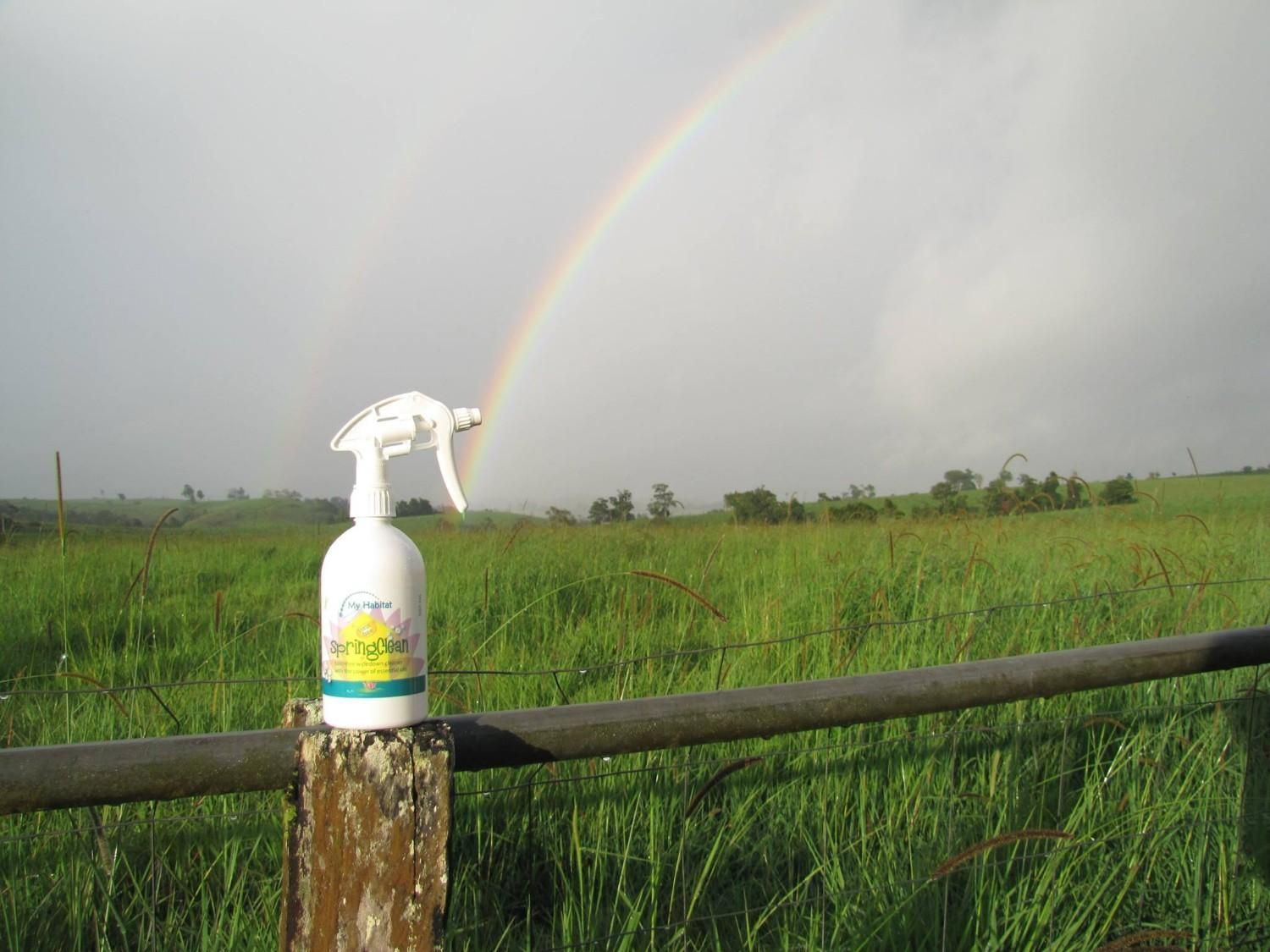 Spray Bottle on Fence Post with A Double Rainbow Over a Green Field — My Habitat Products in Malanda, QLD