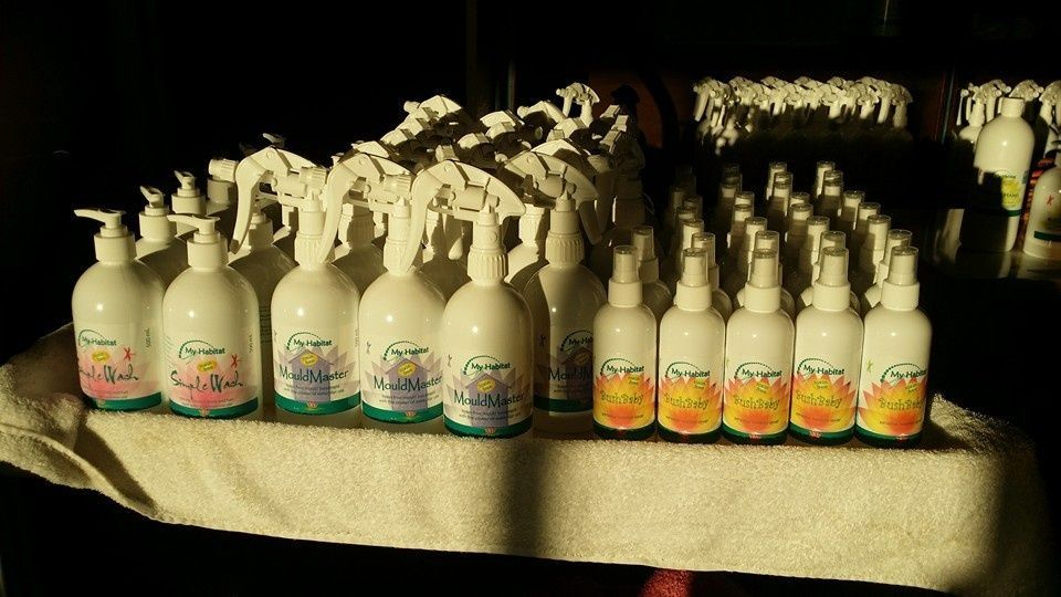 Bottles of Cleaning Products Arranged on A White Towel — My Habitat Products in Malanda, QLD