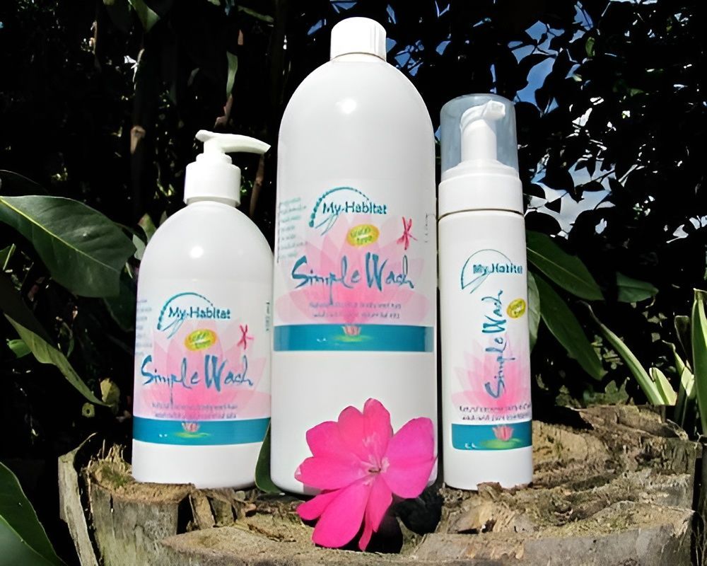 Three white bottles of Simple Wash