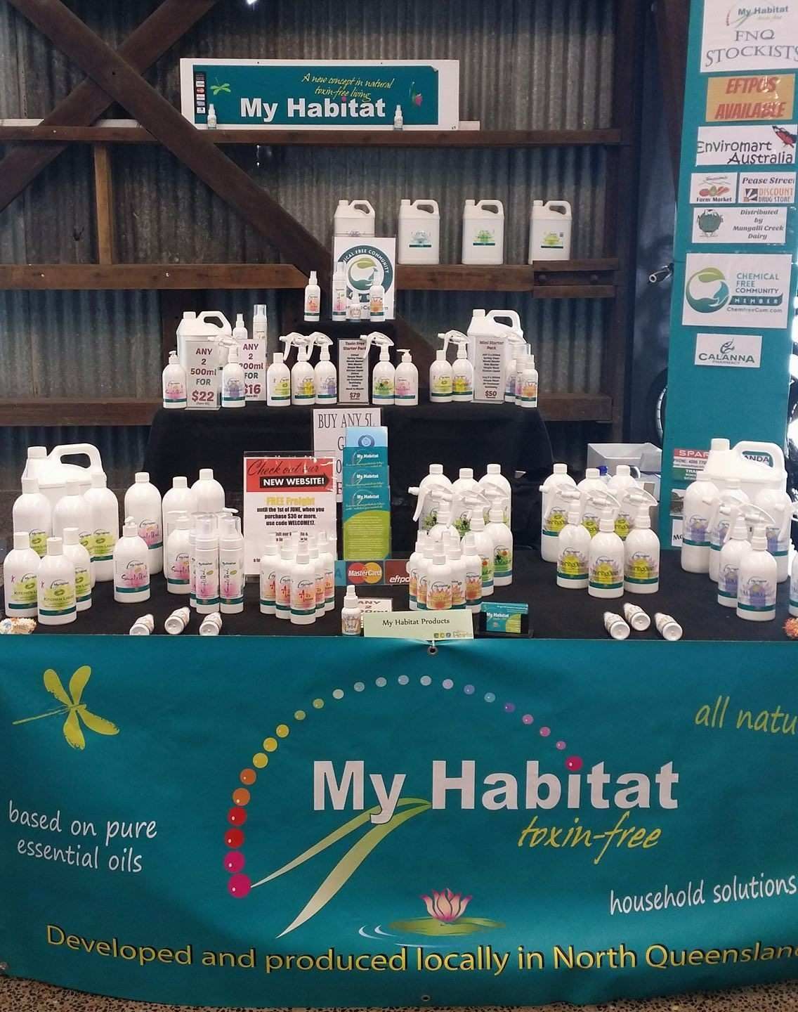 A Vendor Booth for My Habitat Products, Featuring Various White Bottles and Containers — My Habitat Products in Malanda, QLD