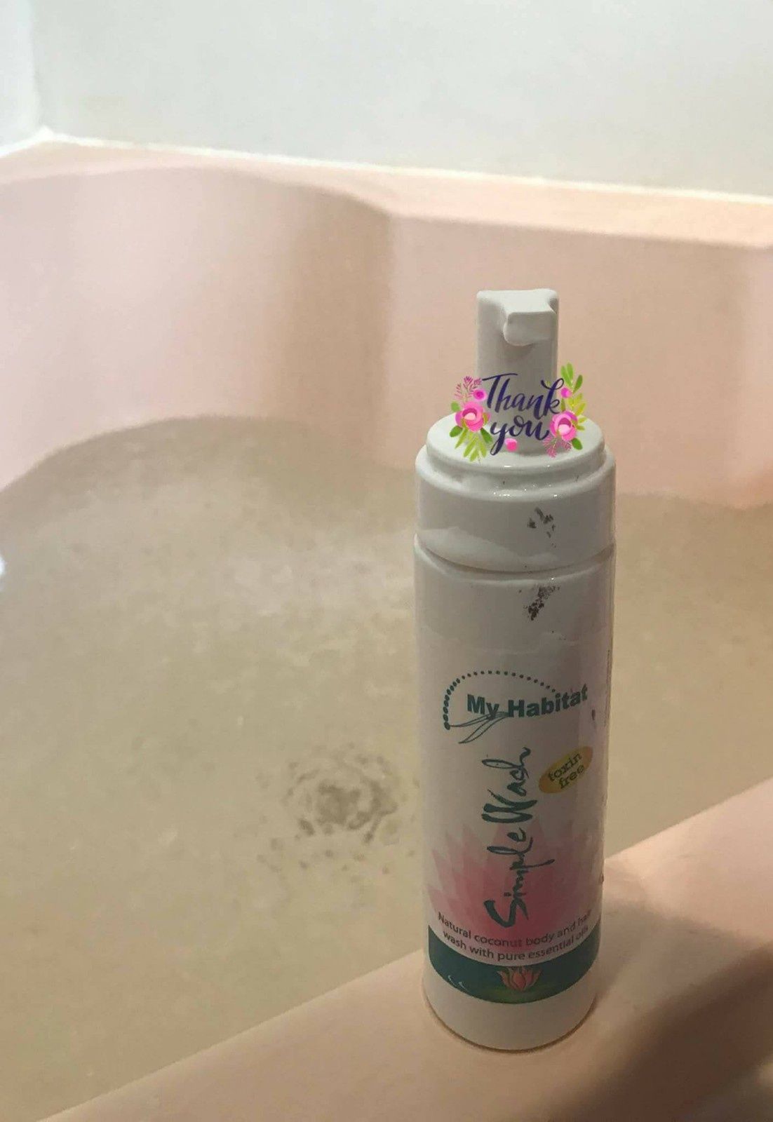 Woman Washing Her Back with A Blue Sponge, Smiling — My Habitat Products in Cairns, QLD