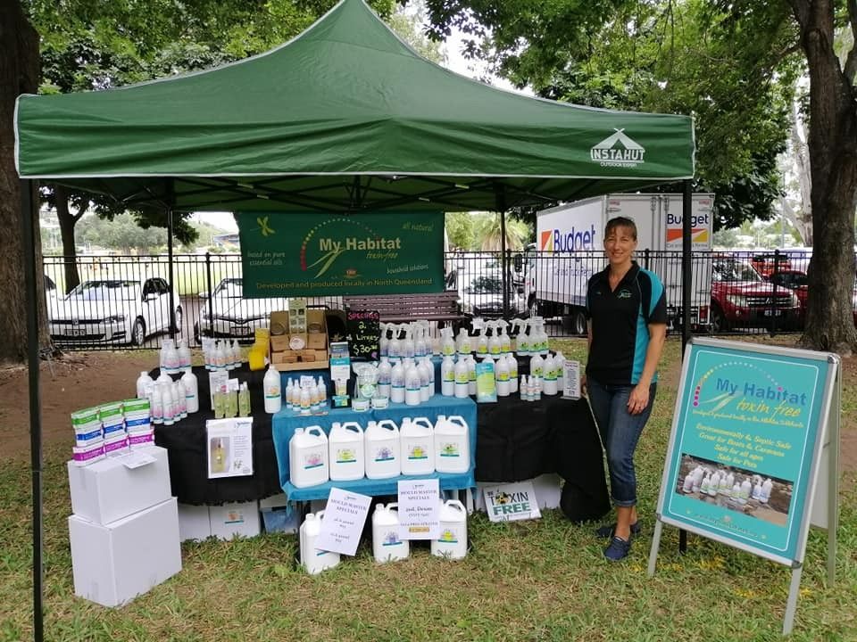 Woman at A Market Stall Under a Green Tent Selling Cleaning Products — My Habitat Products in Malanda, QLD