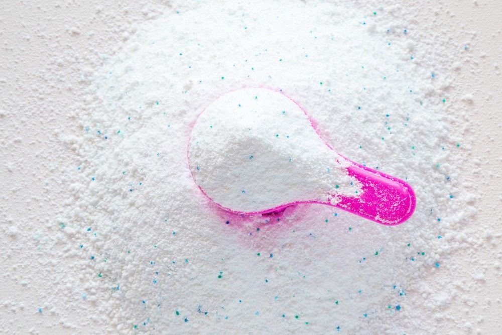 Pink Scoop Filled with White Laundry Detergent on A Pile of Detergent — My Habitat Products in Townsville, QLD
