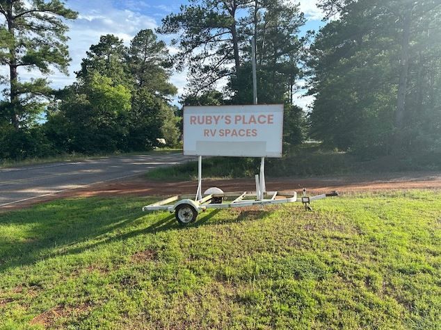 A sign that says ruby 's place on it