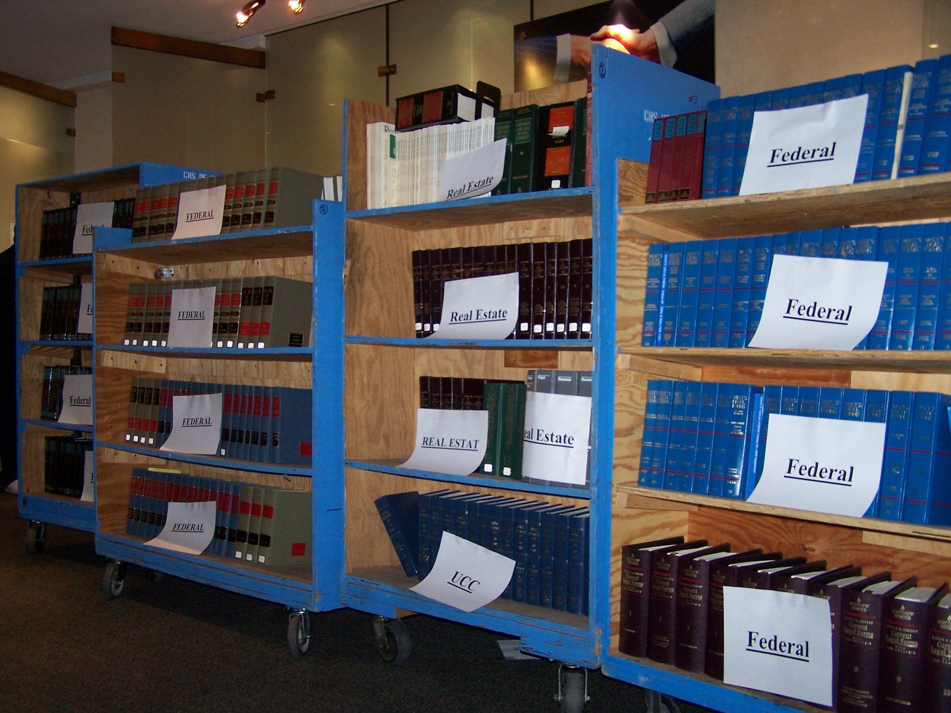 A row of bookshelves with labels that say extra