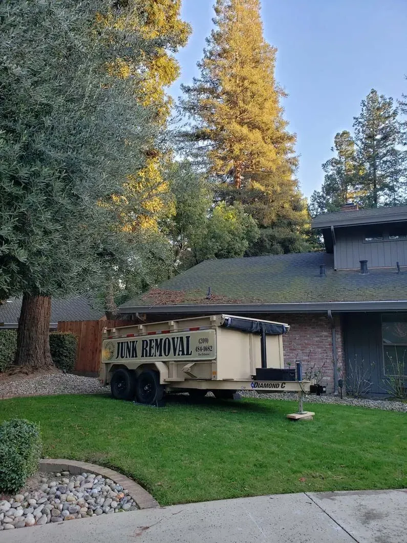 A trailer is parked in front of a house.