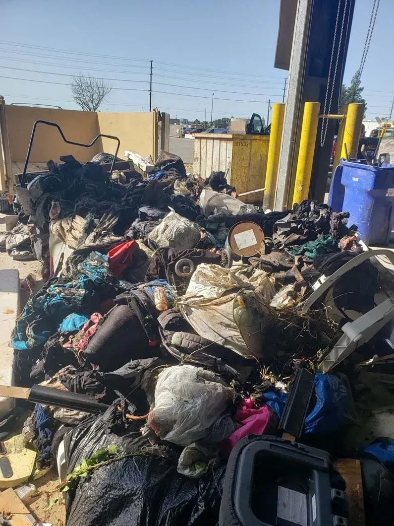 A pile of trash is sitting on the ground in a warehouse.