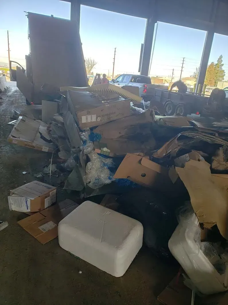 A pile of trash is sitting on the ground in a building.