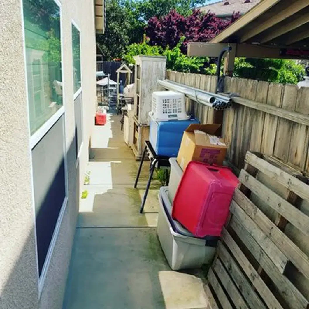 A wooden fence with a bunch of boxes on it