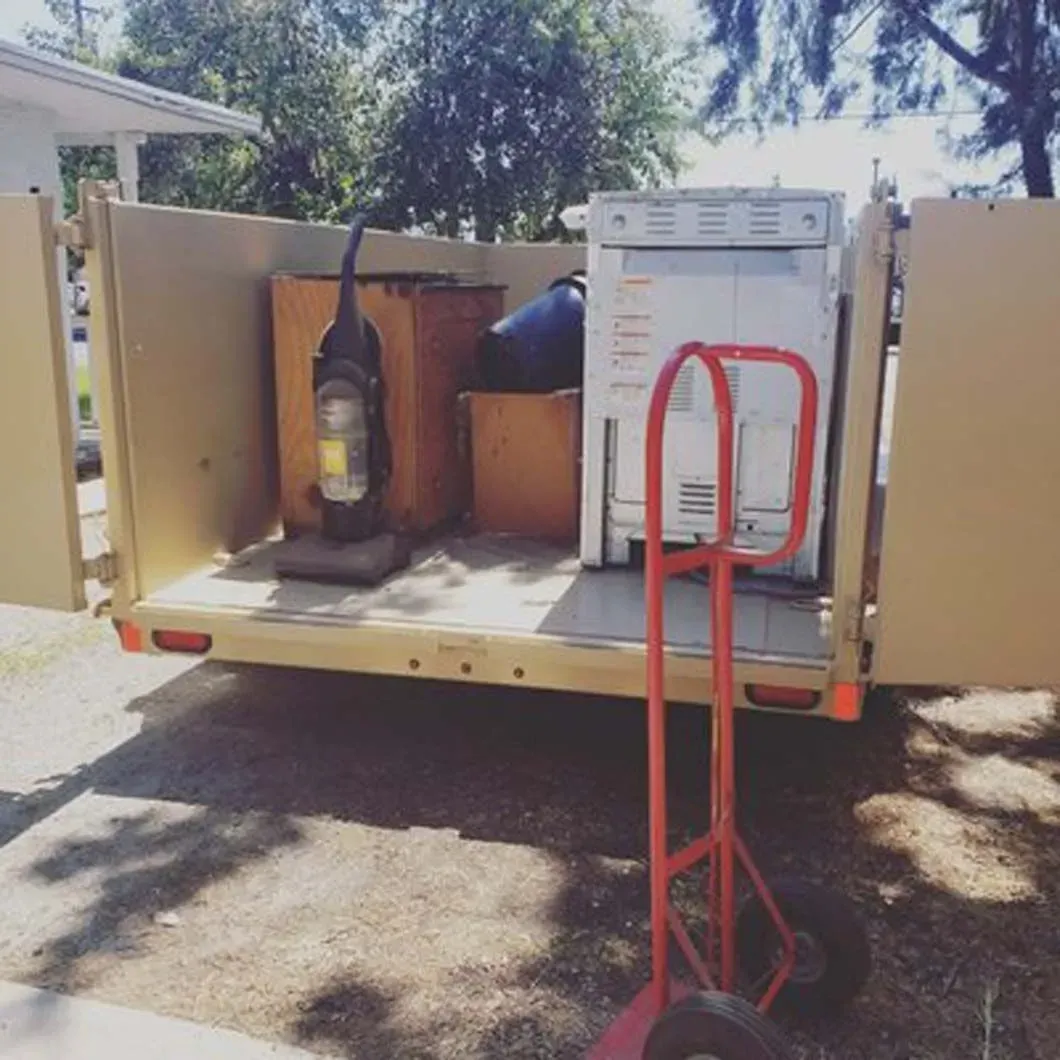 A vacuum cleaner is in the back of a truck