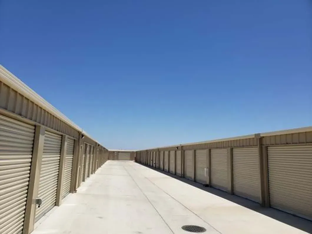 A row of storage units with a blue sky in the background.