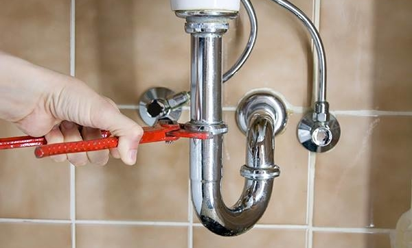 Plumber Fixing a Sink in Bathroom - Sewer Service in Orange County, CA