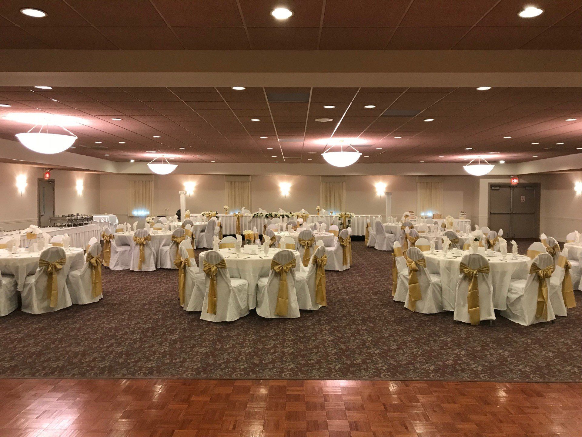 Weddings — Bride And Groom With Family And Guests Sitting Around The Table In Redford, MI