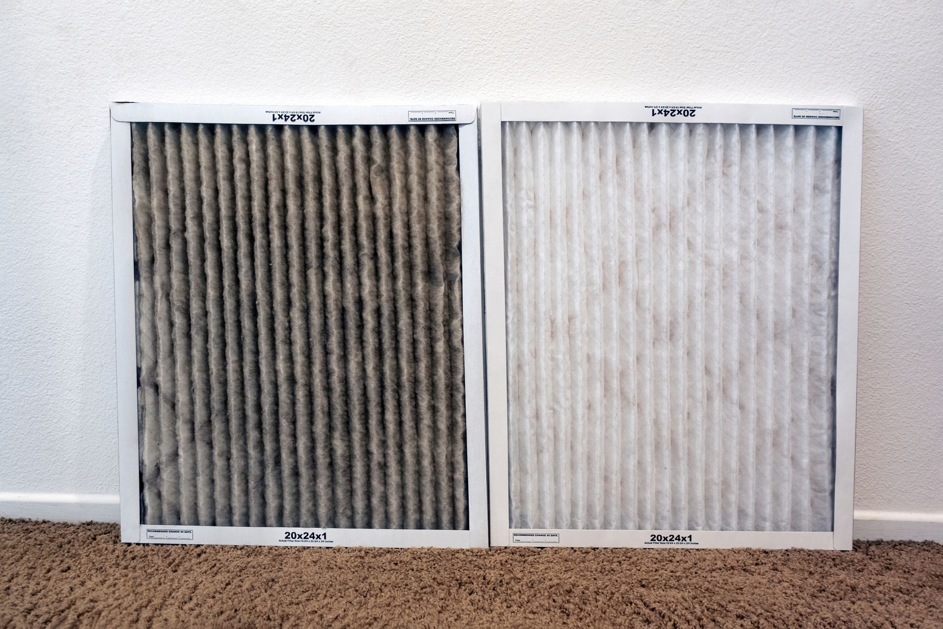 A dirty, dark HVAC air filter side-by-side with a clean, white replacement filter.