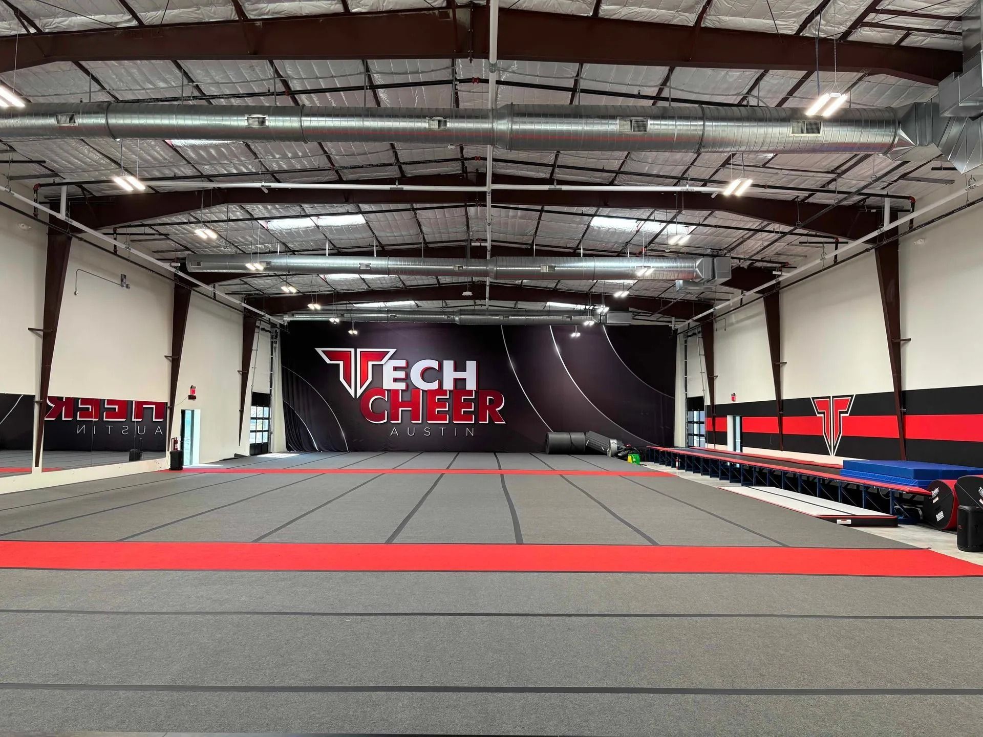 Large Cheerleading Gym with Grey Floor — Cedar Park, TX — Tech Cheer Large Cheerleading Gym with Grey Floor — Cedar Park, TX — Tech Cheer