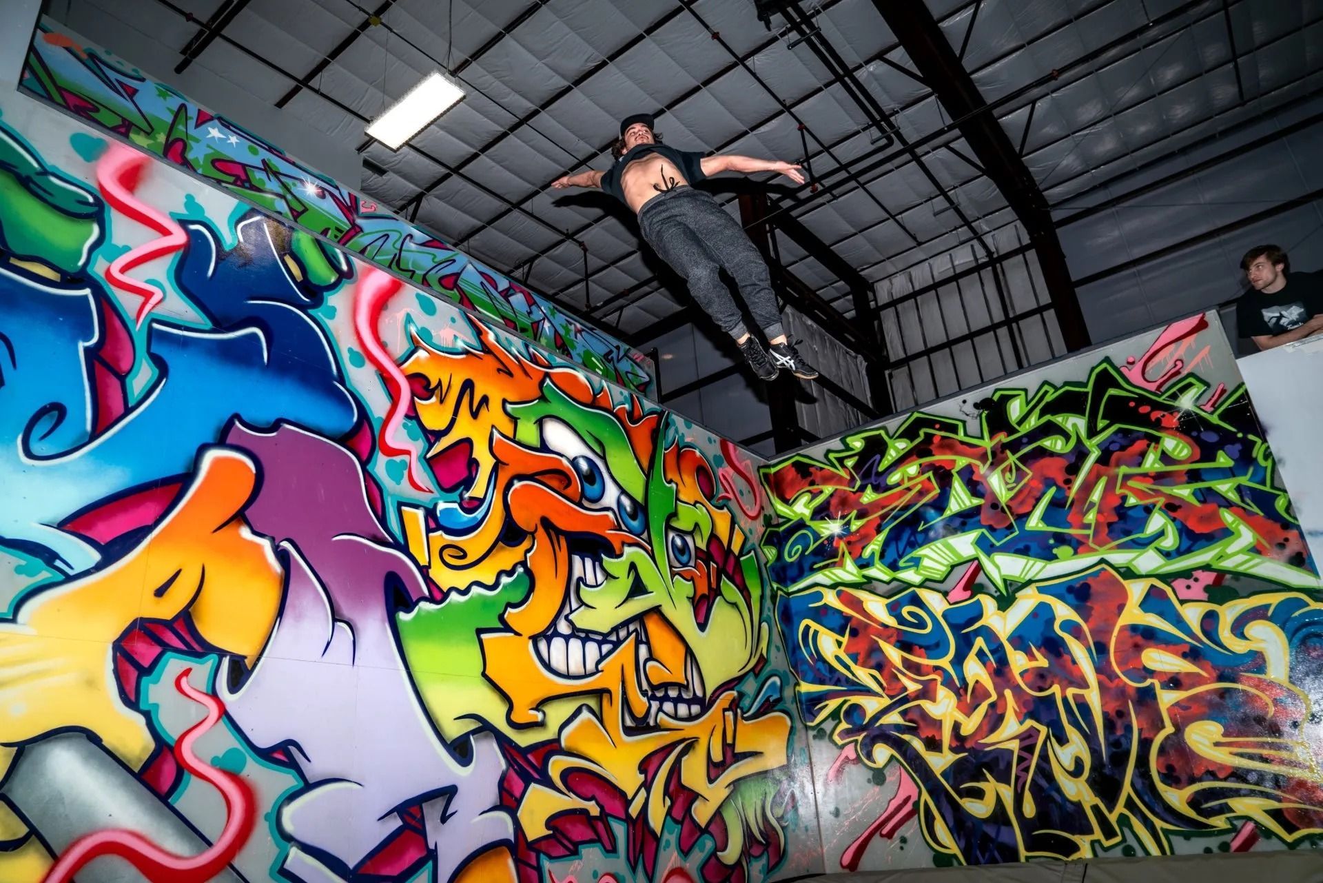 Man Jumping Between Graffiti-Covered Walls — Cedar Park, TX — Tech Cheer