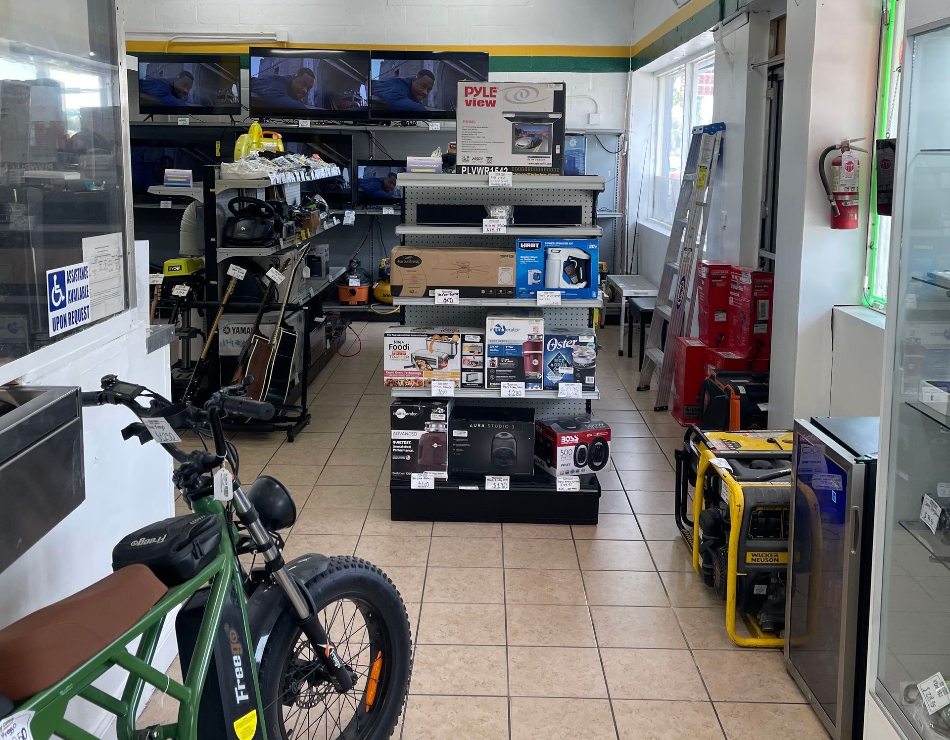 Interior view of King Cash Pawn & Jewelry store showcasing jewelry, musical instruments, electronics, and tools on display. 