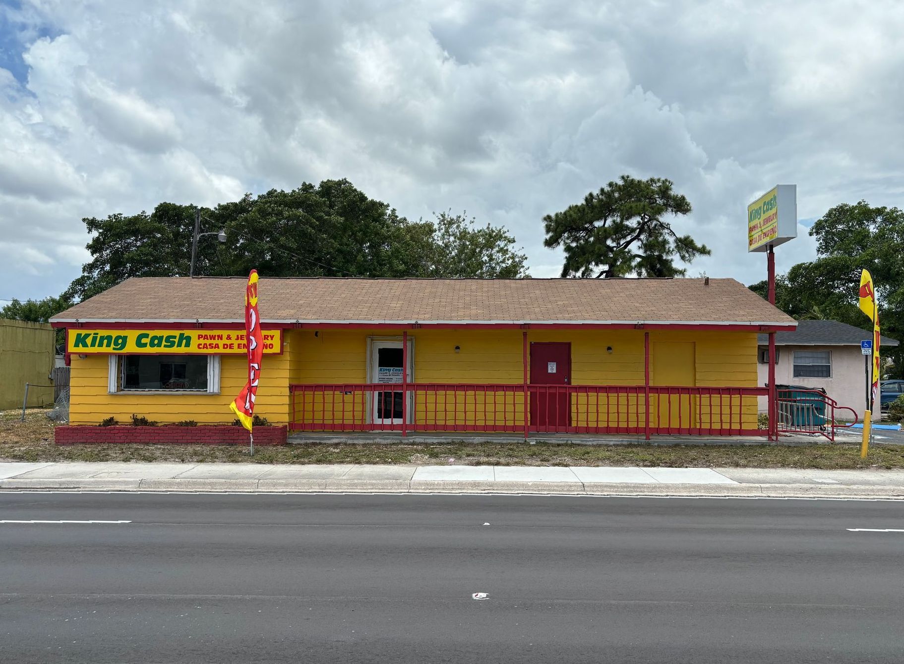 Exterior view of King Cash Pawn & Jewelry store in Opa Locka with yellow building and 