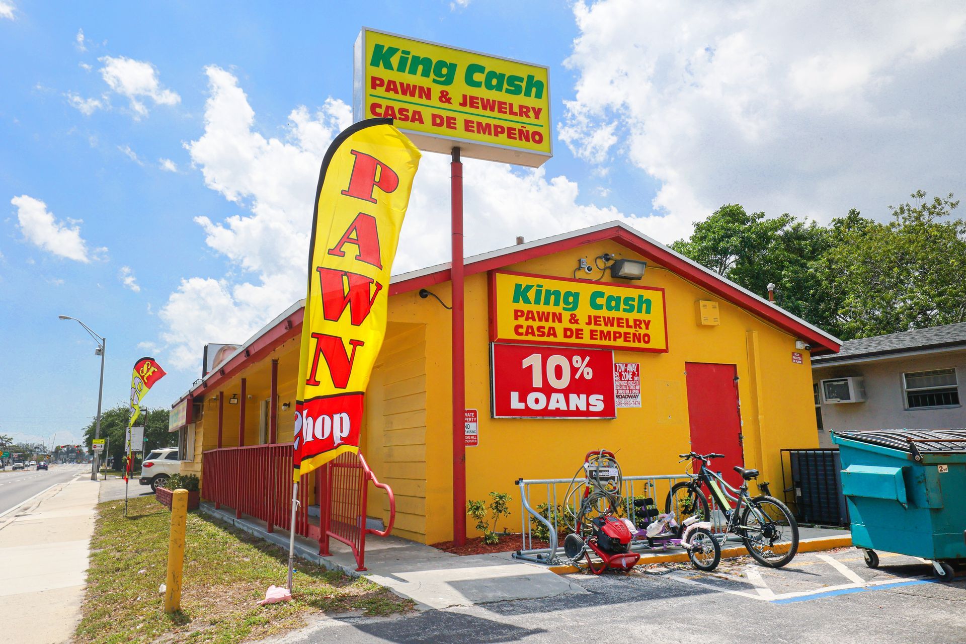 Exterior view of King Cash Pawn & Jewelry store in Opa Locka with yellow building and 
