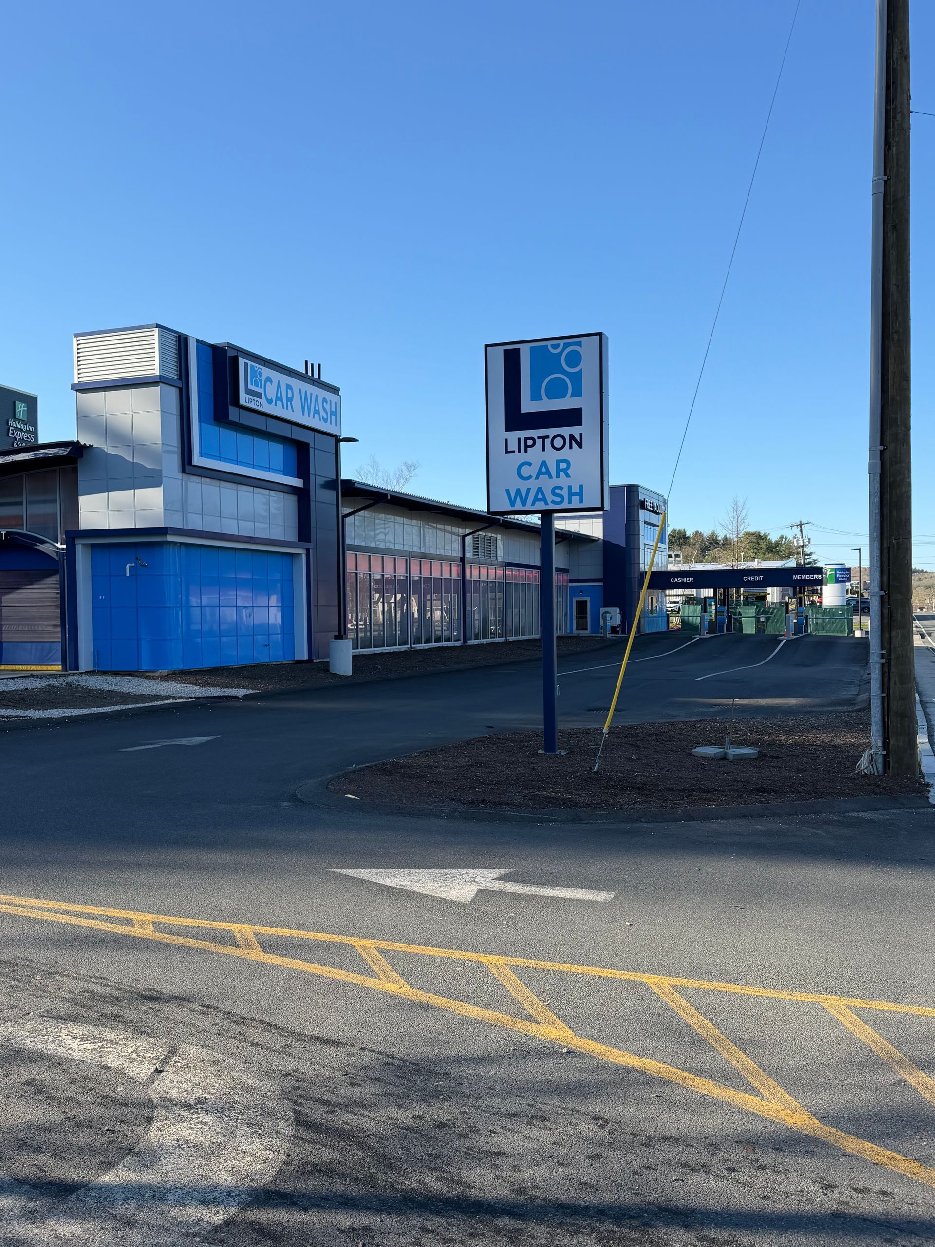 Black car spoiler covered in water droplets.