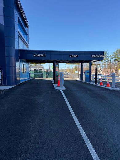 Interior of a black compact car, showcasing the front seats, steering wheel, and dashboard.