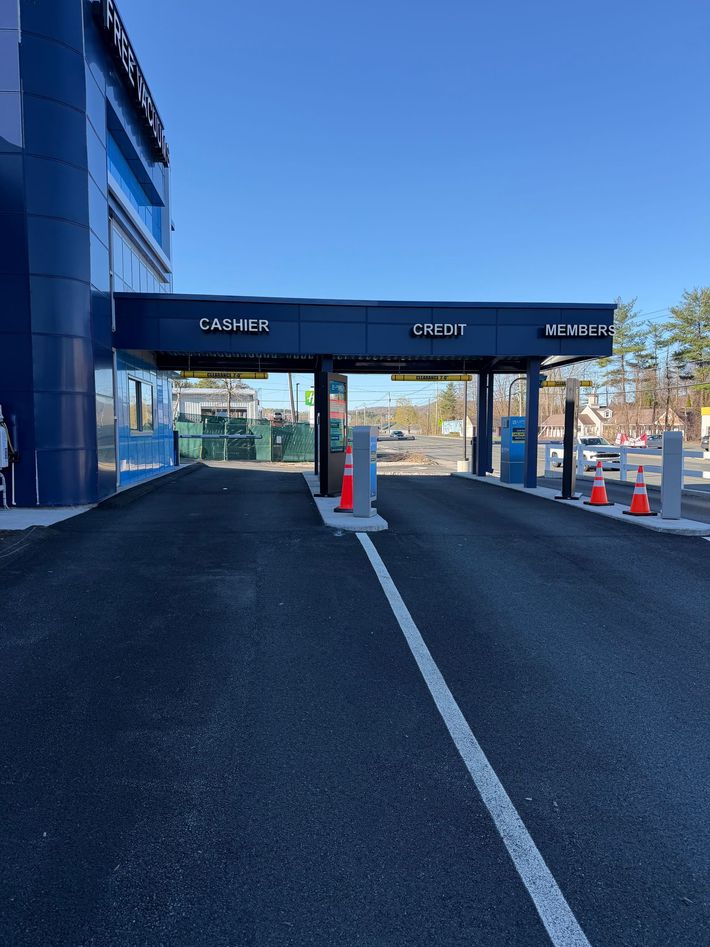 Black car being washed in an automated car wash.